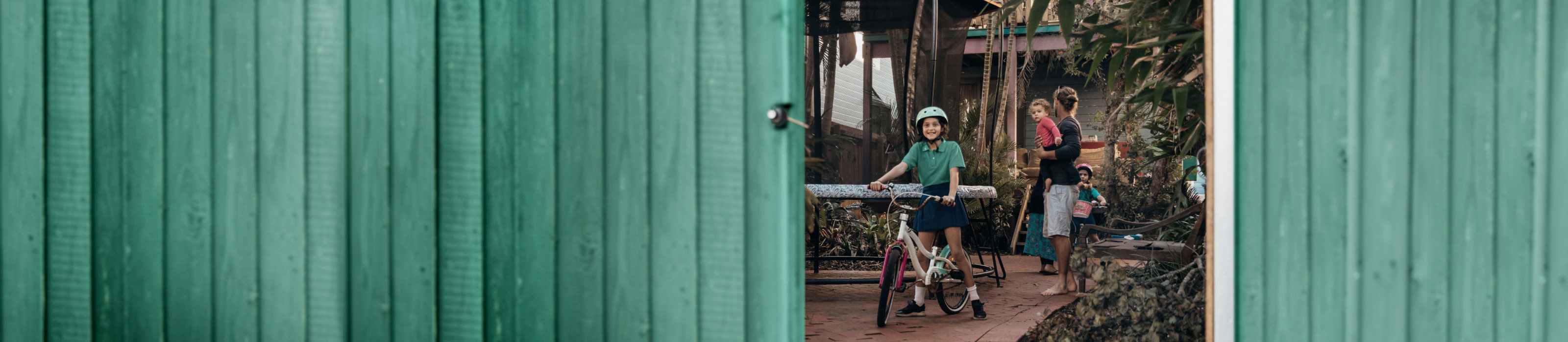 Children on bike in backyard