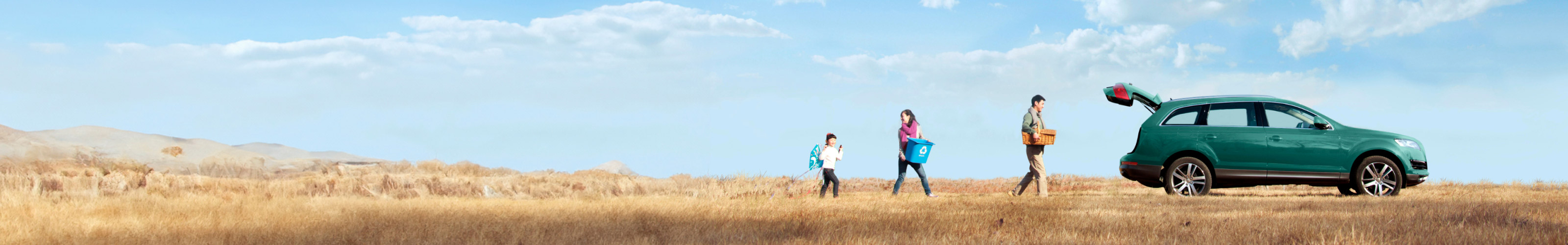 Family walking to car in grasslands