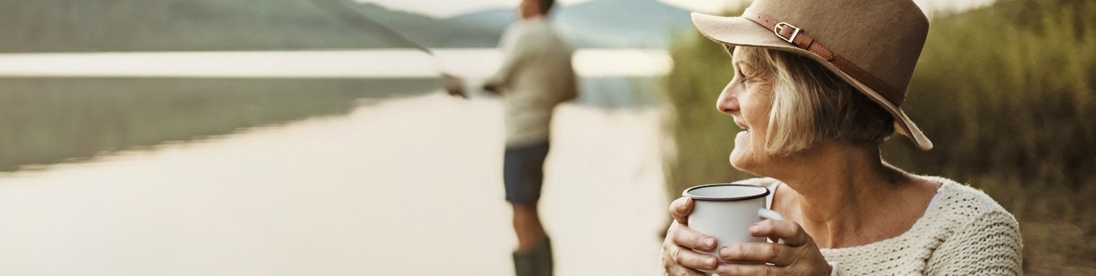 Woman and Man camping on the lake fishing